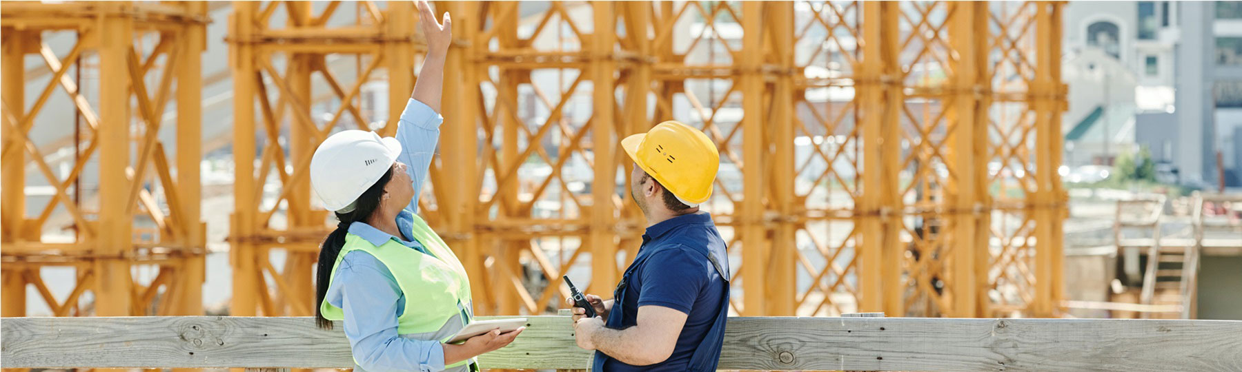 2 construction crew assessing scaffolding